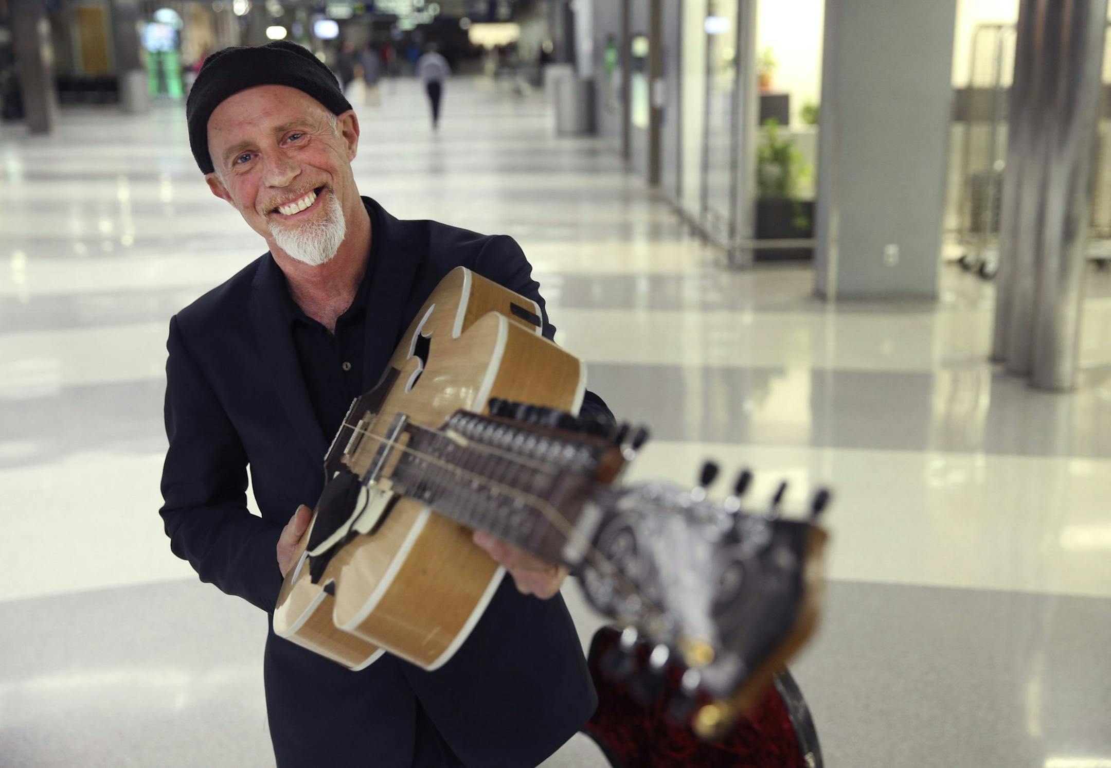 Harry Manx is reunited with his Mohan Veena guitar at Chicago's O'Hare International Airport on March 4, 2014. The practice of thieves targeting luggae on claim carousels at airports came into worldwide attention when the guitar was stolen and Manx publicized it on Facebook. (Nuccio DiNuzzo/Chicago Tribune/MCT)