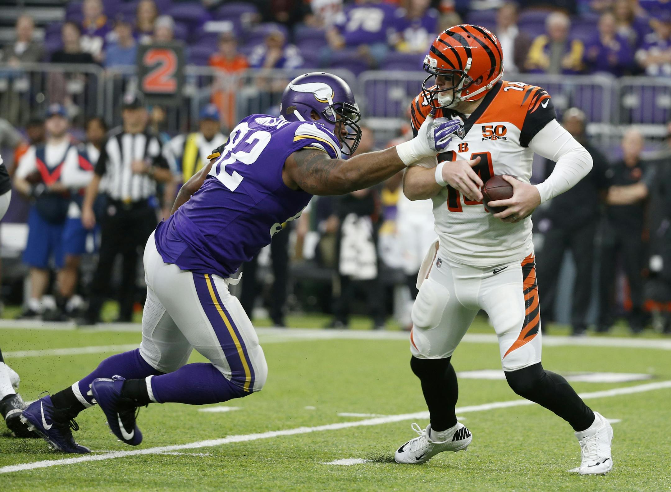 Cincinnati Bengals quarterback Andy Dalton, right, runs from Minnesota Vikings defensive tackle Tom Johnson during the second half of an NFL football game, Sunday, Dec. 17, 2017, in Minneapolis. (AP Photo/Bruce Kluckhohn)