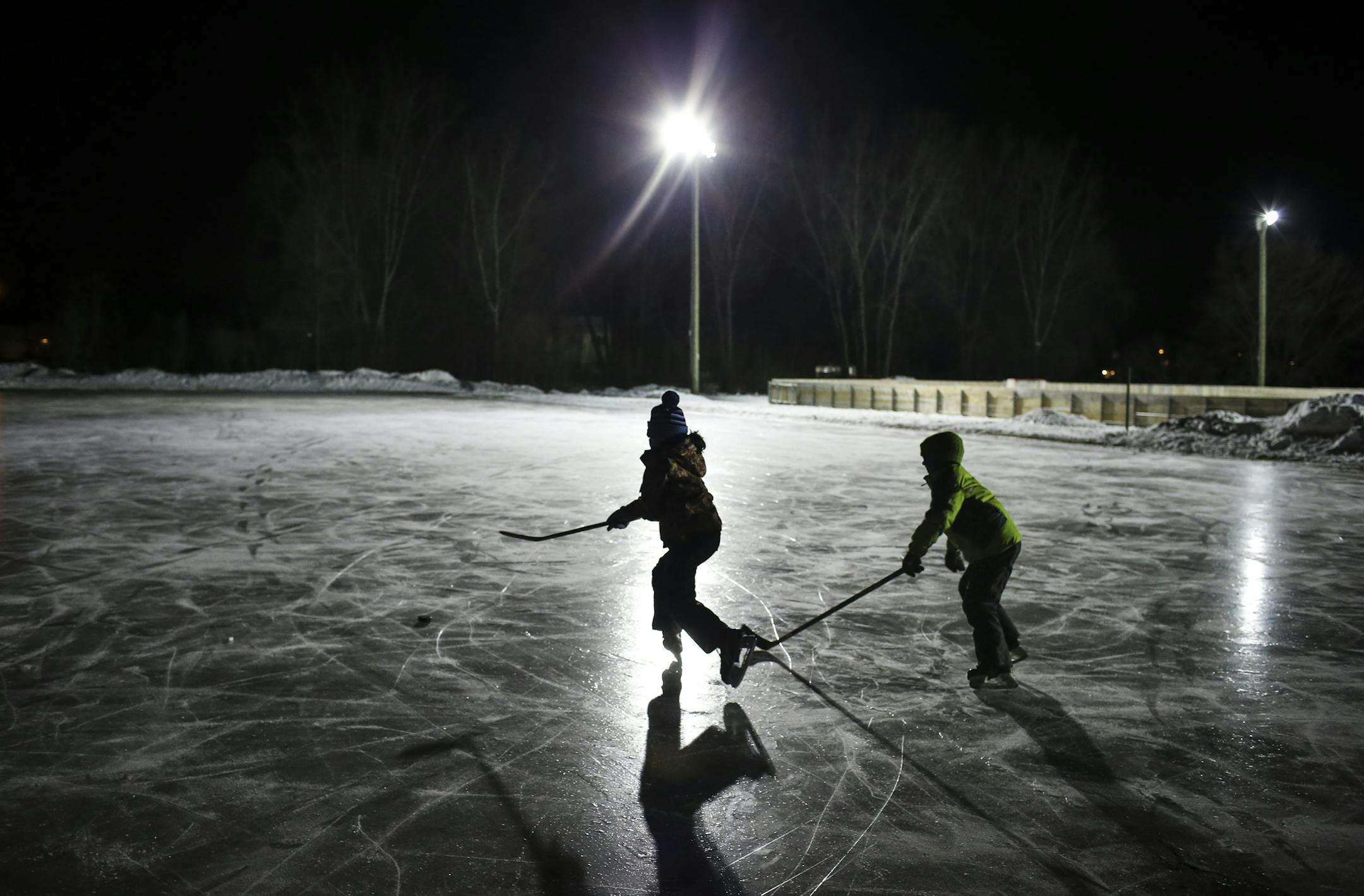 Seven-year-old twins Isabella and Justin Brady played hockey at Happy Acres Park on Dec. 30 in Blaine.