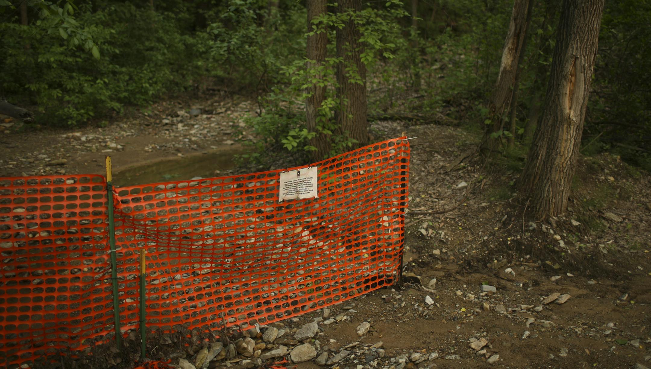 A temporary fence and a sign in Lilydale Regional Park announces the closing of trails that make up the Bruce Vento Watchable WIldlife viewing area and the fossil grounds Monday evening, June 2, 2014. ] JEFF WHEELER &#x2022; jeff.wheeler@startribune.com A year after two elementary school students died in a landslide, temporary fences prevent access to the bluff in Lilydale Regional Park in St. Paul where the ground gave way.