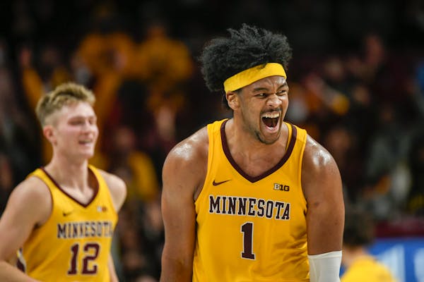 Gophers senior Eric Curry (1) reacted after making a three-pointer in Saturday’s victory against Penn State at Williams Arena.