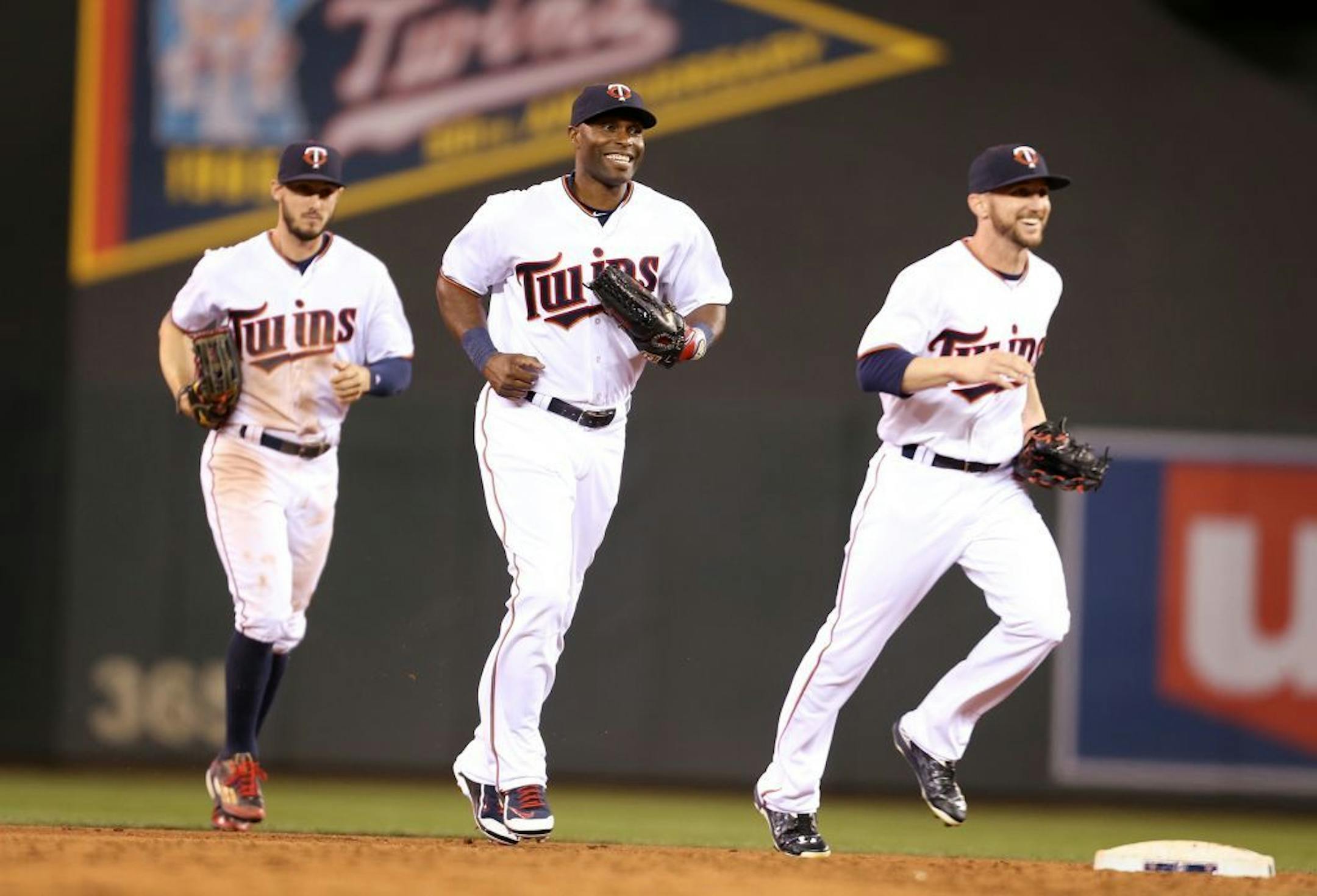 Jordan Schafer, from left, Torii Hunter, and Shane Robinson run in from outfield to celebrate the Minnesota Twins 8-7 win over the Oakland Athletics at Target Field in Minneapolis on Monday, May 4, 2015.