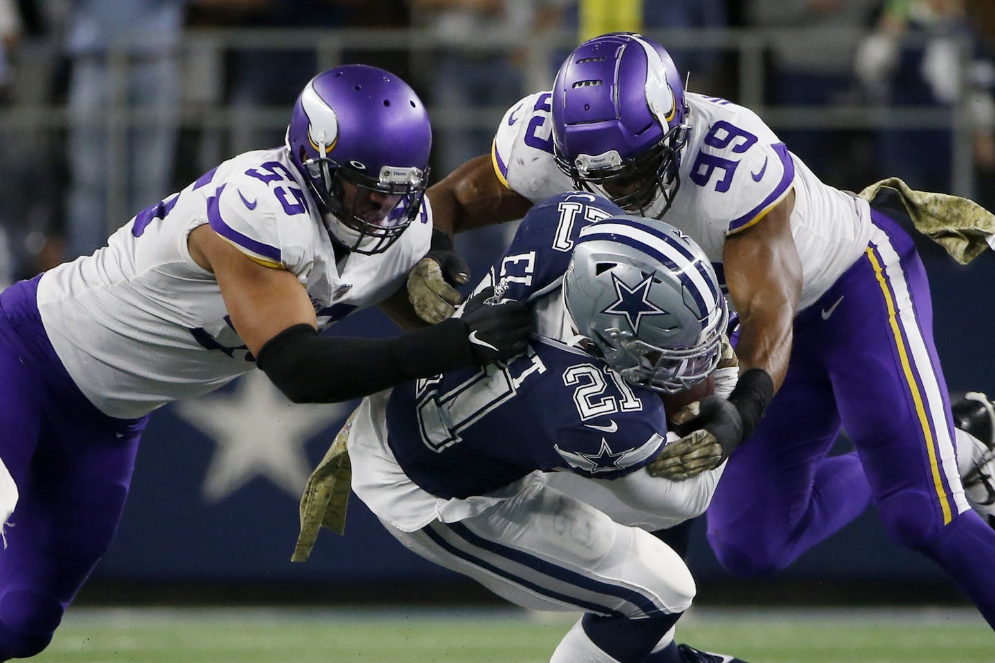 Minnesota Vikings' Anthony Barr, left, and Danielle Hunter (99) combine to stop Dallas Cowboys running back Ezekiel Elliott (21) in the first half of an NFL football game in Arlington, Texas, Sunday, Nov. 10, 2019. (AP Photo/Ron Jenkins)