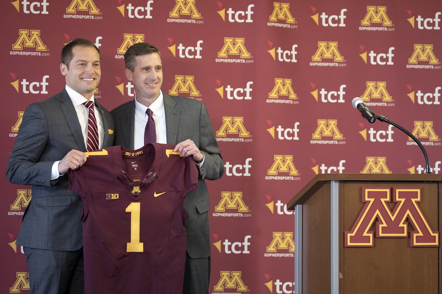 Newly named University of Minnesota football coach P.J. Fleck and athletic director Mark Coyle held up Fleck's jersey during a press conference Friday.