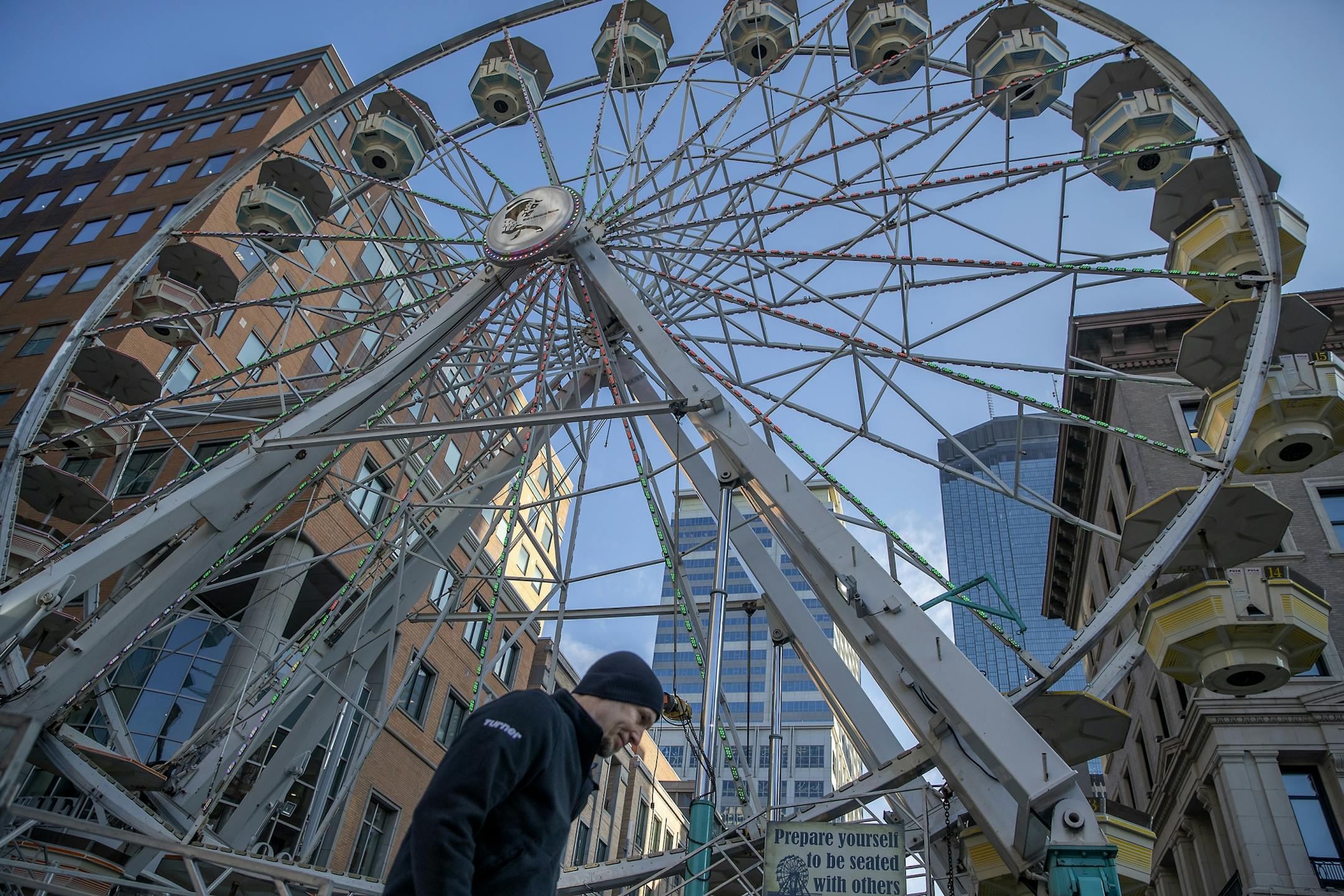 Tim Leininger, cq, made his way to and from a giant Ferris wheel where he was placing signage in preparation for the Final Four festivities, Wednesday, April 3, 2019 in Minneapolis, MN. There will be a four-day tailgate on Nicollet Mall and the wheel is one of the attractions added to wow out-of-town guests.