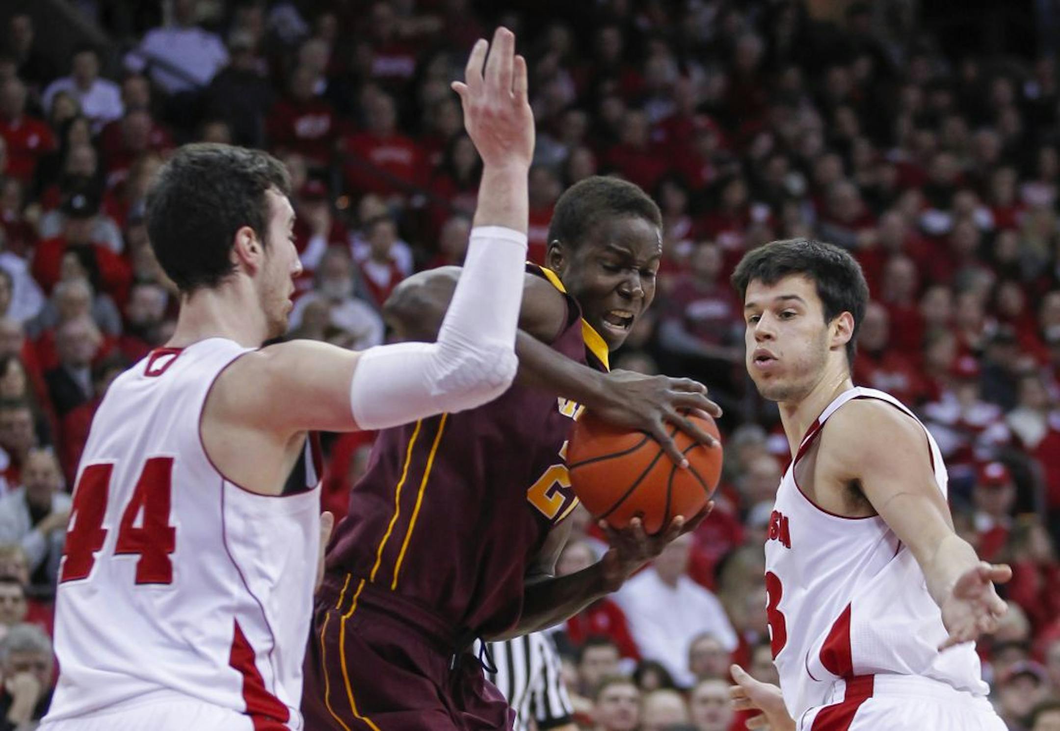 Minnesota's Bakary Konate, center, battles between Wisconsin's Frank Kaminsky (44) and Duje Dukan during the first half of an NCAA college basketball game Saturday, Feb. 21, 2015, in Madison, Wis.