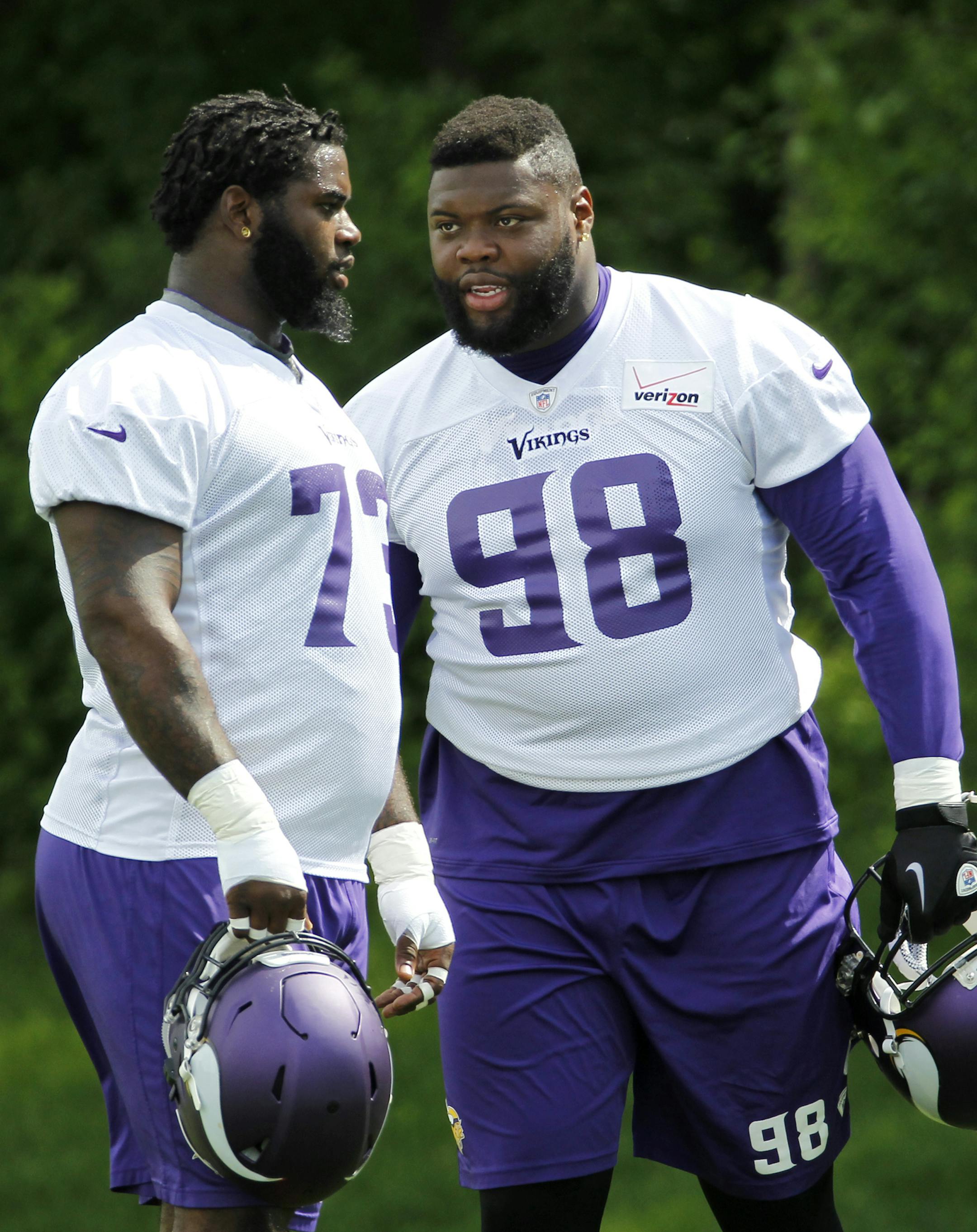 Minnesota Vikings defensive tackle Linval Joseph (98) talks with Sharrif Floyd during an NFL organized team activity in Eden Prairie, Minn., Thursday, June 5, 2014. (AP Photo/Ann Heisenfelt)