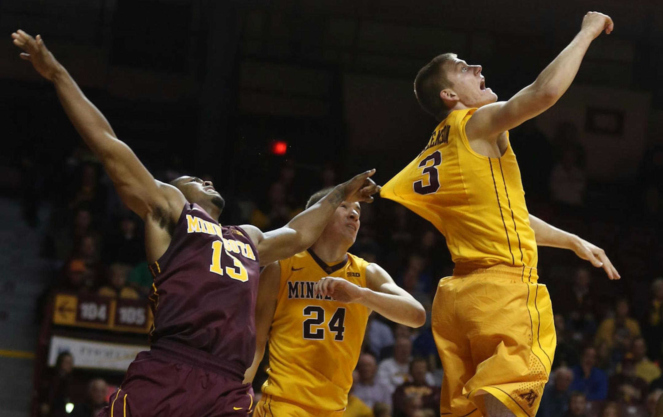 Maroon's Maverick Ahanmisi pulled the jersey of Gold's Wally Ellenson during the second half of the Gopher's scrimmage at Williams Arena in Minneapolis Min., Friday, October 18, 2013. Maroon won over Gold 61-53. artribune.com