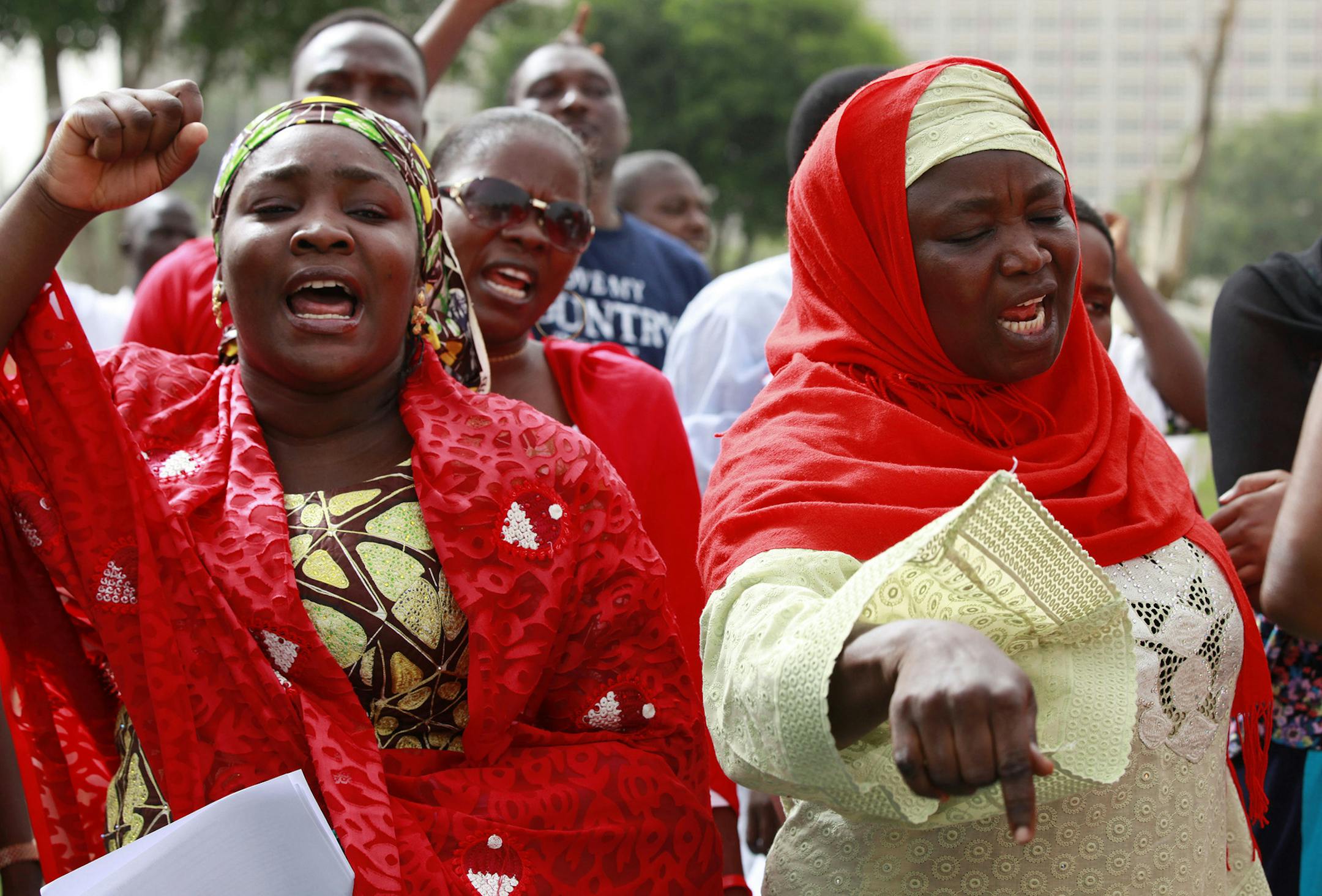 Women shout slogans during a rally calling on the Government to rescue the school girls kidnapped from the Chibok Government secondary school in Abuja, Nigeria, Sunday May 11, 2014. The failure to rescue the kidnapped girl students who remain captive after some four weeks has attracted mounting national and international outrage, and one of the teenagers who escaped from the Islamic extremists who abducted the hundreds of schoolgirls, science student Sarah Lawan said Sunday in an interview with