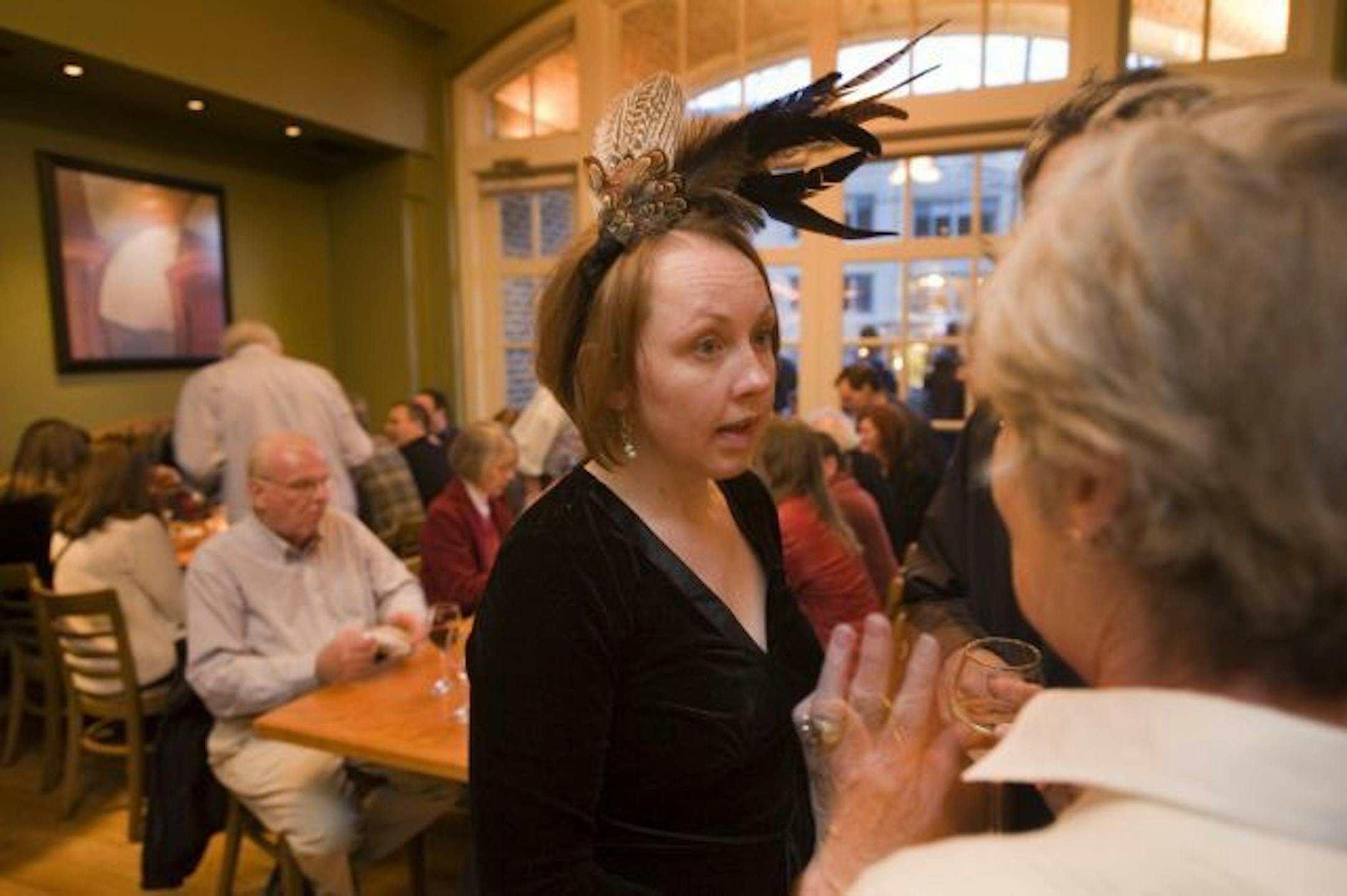Blackbird restaurant co-owner Gail Mollner talked with many customers at the fundraiser held Sunday night at the Cafe Twenty Eight. Seen here talking to long-time customers Martha and Bob Sumada.