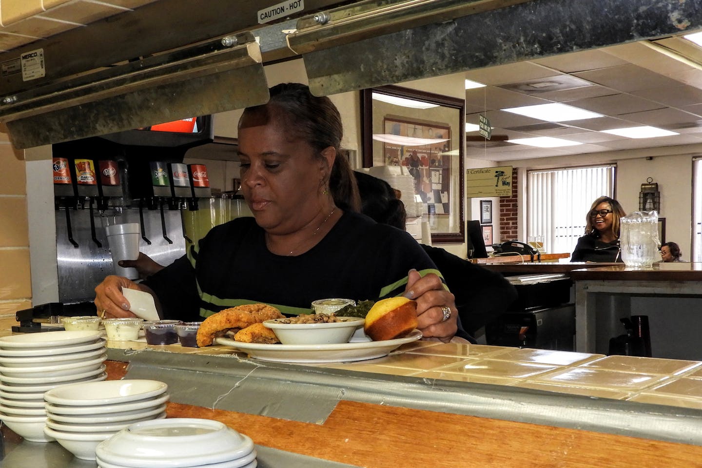 The Four Way owner Patrice Thompson checks on orders during the Sunday lunchtime rush at her restaurant in Memphis. Thompson said King routinely stopped by for soul food when he was in town. (Jay Jones/Chicago Tribune/TNS)