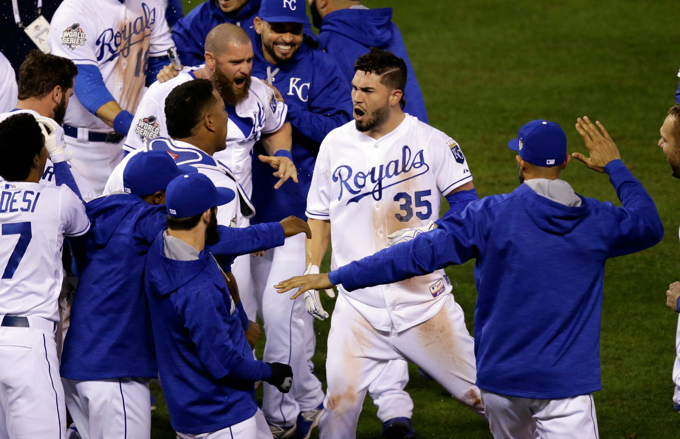 Kansas City Royals' Eric Hosmer is congratulated after hitting a sacrifice fly during the 14th inning of Game 1 of the World Series against the New York Mets on Wednesday, Oct. 28, 2015, in Kansas City, Mo. The Royals won 5-4 to take a 1-0 lead in the series.