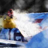 A worker deiced a FedEx plane near Minneapolis-International Airport after the heavy snowfall
