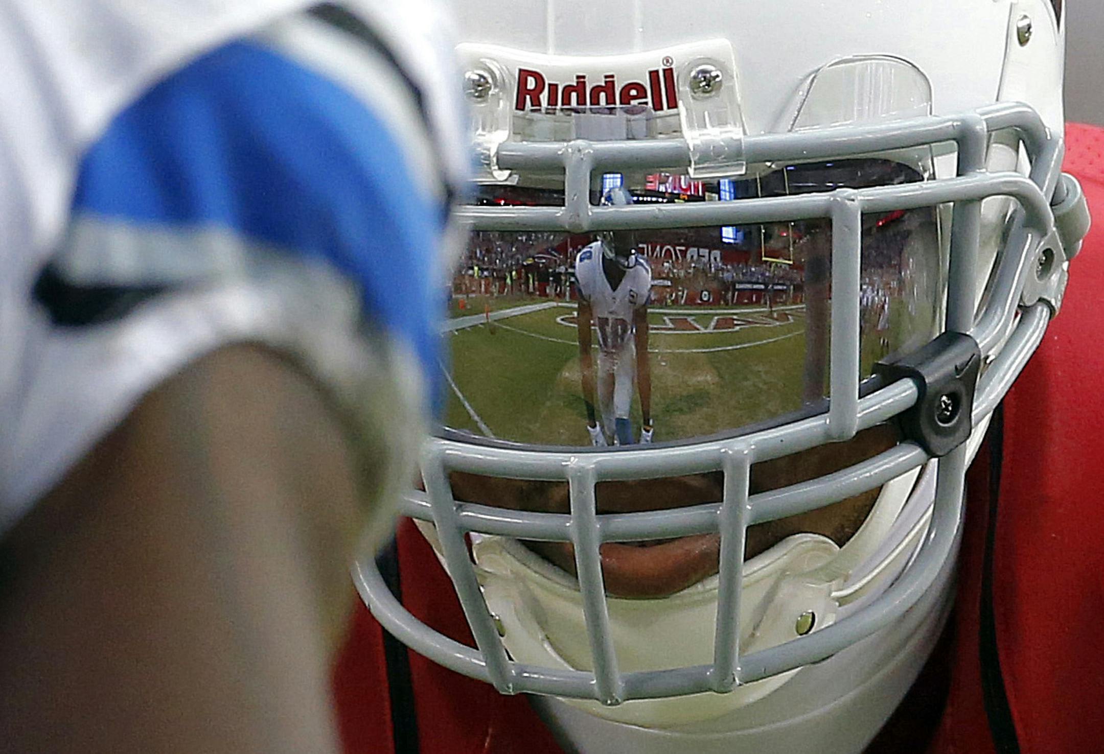 Detroit Lions wide receiver Calvin Johnson is reflected in the face mask of Arizona Cardinals defensive back Tyrann Mathieu during the second half of a NFL football game, Sunday, Sept. 15, 2013, in Glendale, Ariz. (AP Photo/Darryl Webb)