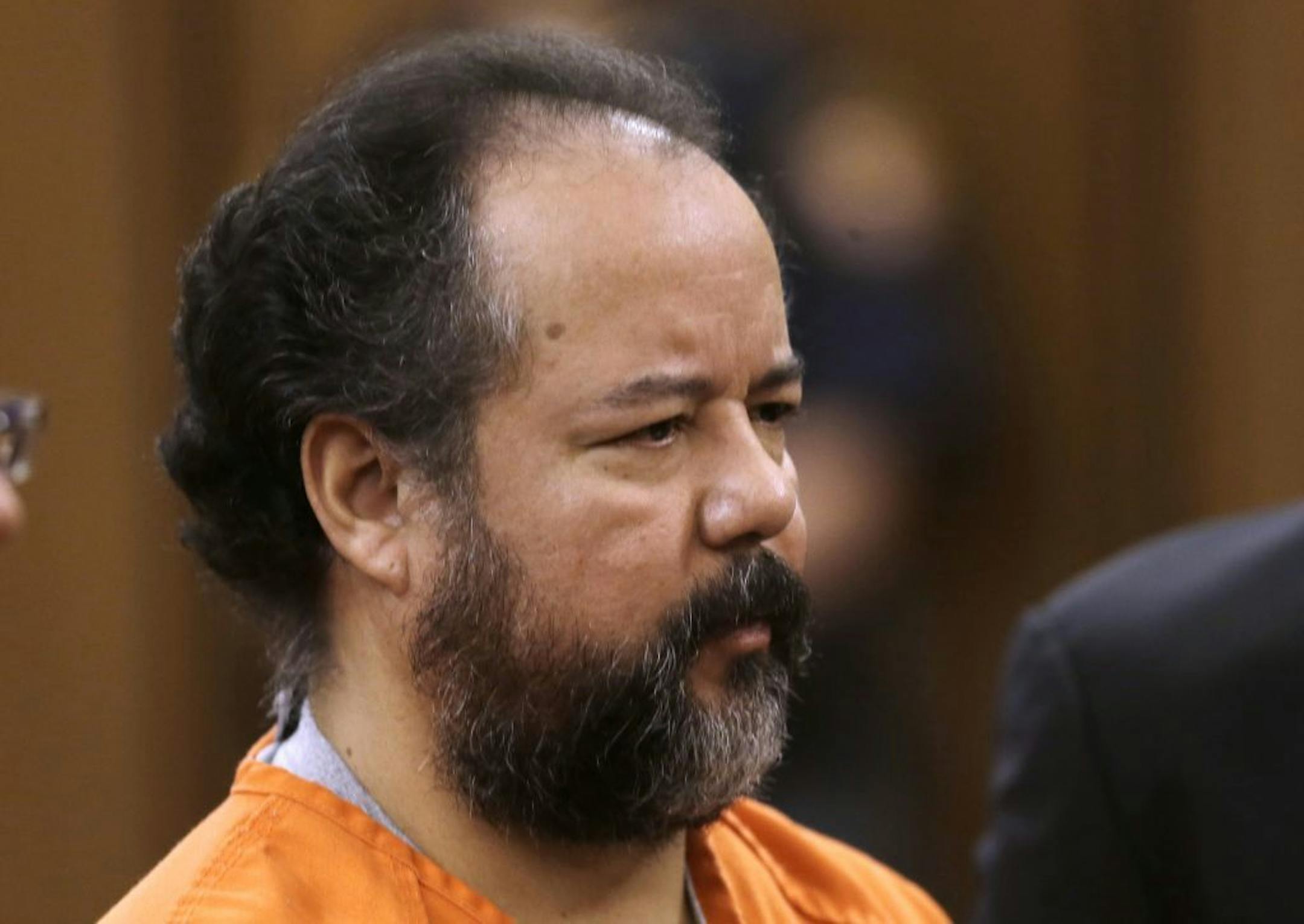 Ariel Castro stands before a judge during his arraignment on an expanded 977-count indictment Wednesday, July 17, 2013, in Cleveland. Castro is charged with kidnapping and raping three women over a decade in his Cleveland home. Castro pleaded not guilty to 512 counts of kidnapping and 446 counts of rape.
