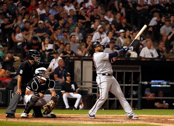Nelson Cruz watches his two-run home run during the fifth inning on Thursday in Chicago.