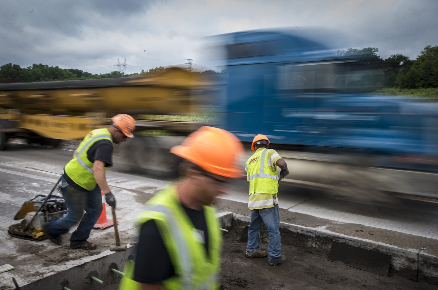 Construction workers Nick Norman, Joe Olson and Eldio Ferreira worked on a lane of Highway 55 in Inver Grove Heights, Minn. as trucks and cars flew past in the adjoining lane. Starting Aug. 1, the current "Fines Double in Work Zones" standard will be replaced by clearer ones, reading "$300 minimum fines." ] REN&#xc9;E JONES SCHNEIDER &#x2022; reneejones@startribune.com