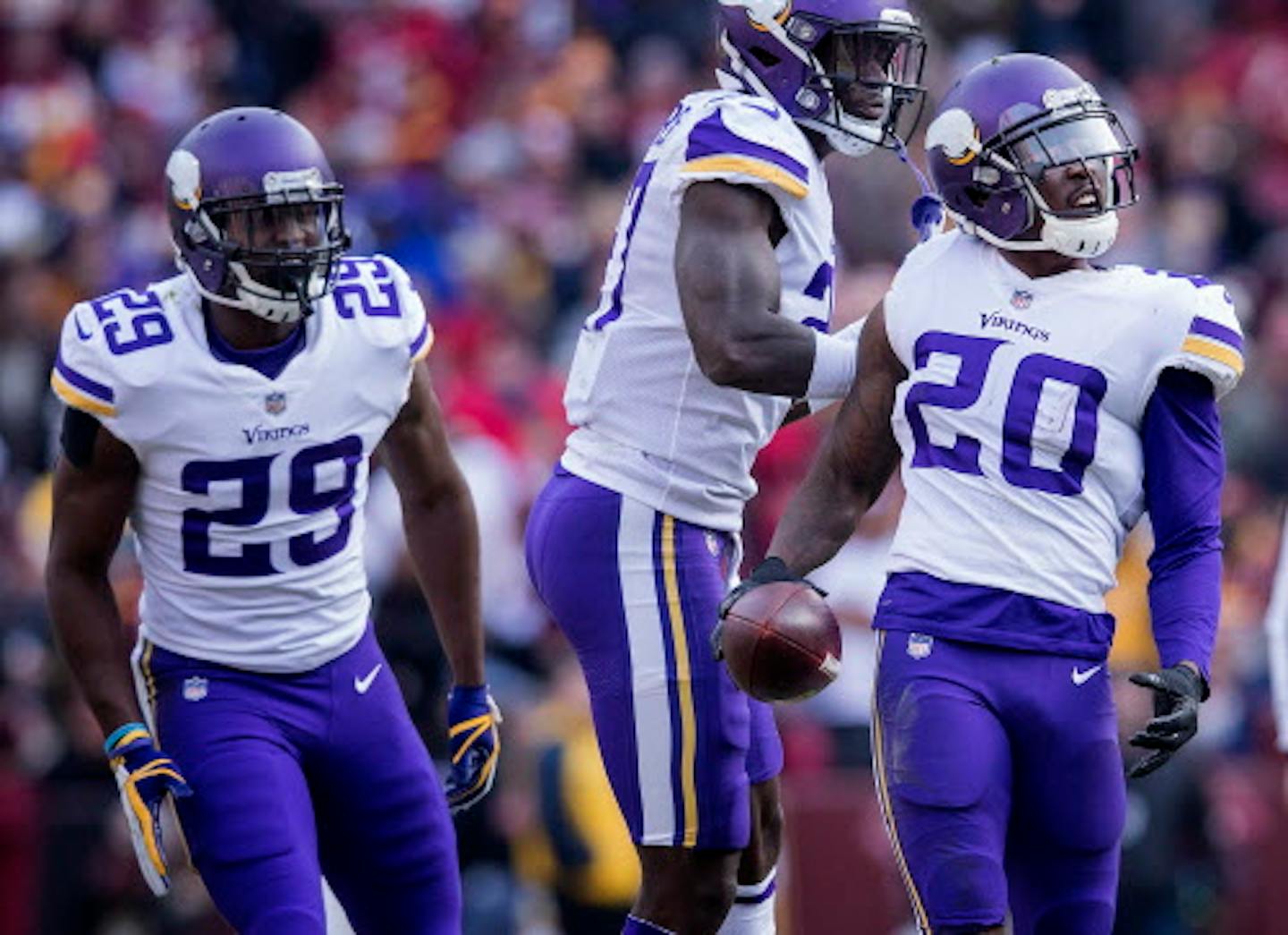 MacKensie Alexander (23) celebrated with teammates after he intercepted a Kirk Cousins (8) pass in the second quarter.