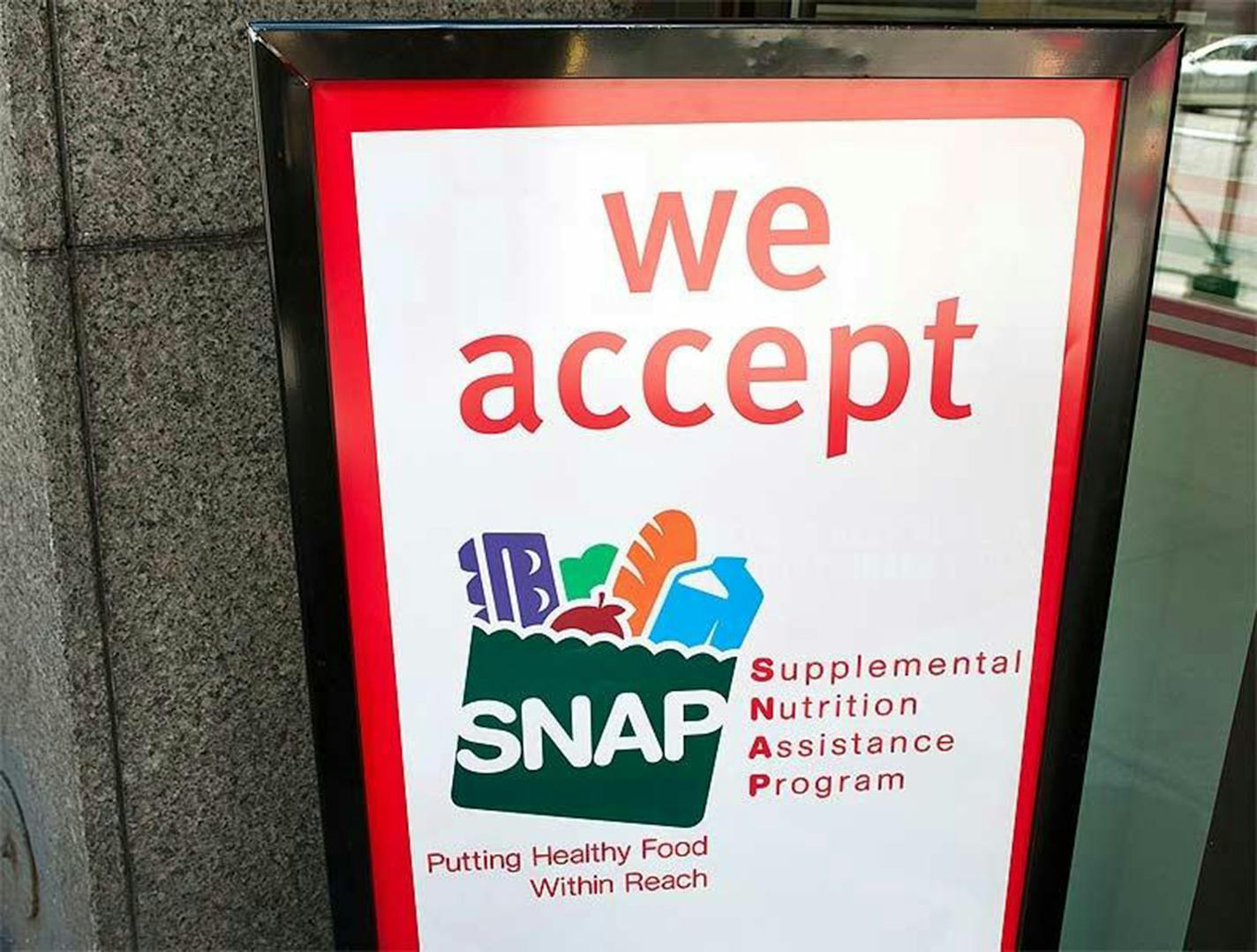 A sign indicates a store that accepts the Supplemental Nutritional Assistance Program or SNAP, the official name of the food stamp program. (File photo/The Columbus Dispatch/TNS) ORG XMIT: 1389439