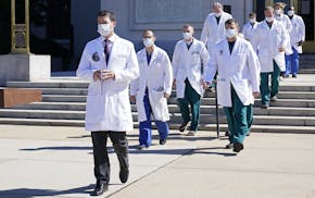 Dr. Sean Conley, physician to President Donald Trump, is followed by a team of doctors for a briefing with reporters at Walter Reed National Military 