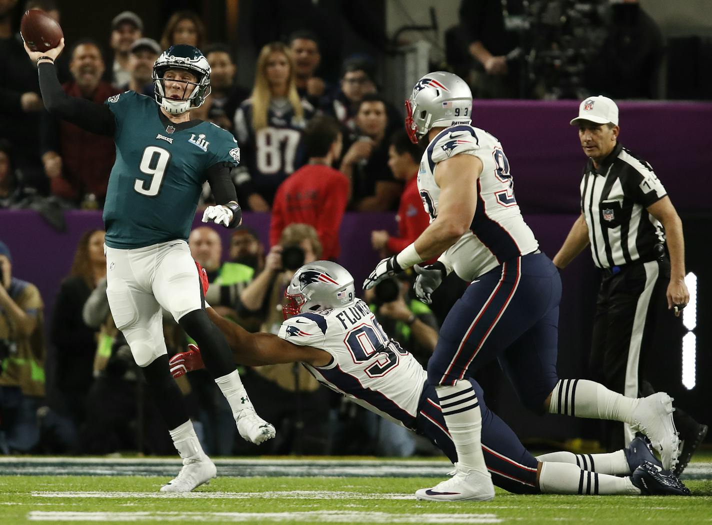 Philadelphia Eagles quarterback Nick Foles (9) got a pass away under pressure from New England Patriots defenders Trey Flowers (98) and Lawrence Guy (93) in the first half of Super Bowl LII.