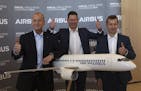 Airbus CEO Tom Enders, left, CFO Harald Wilhelm and president of Airbus Commercial Aricraft Guillaume Faury, thumb up before the presentation of Airbu