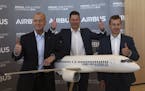 Airbus CEO Tom Enders, left, CFO Harald Wilhelm and president of Airbus Commercial Aricraft Guillaume Faury, thumb up before the presentation of Airbu