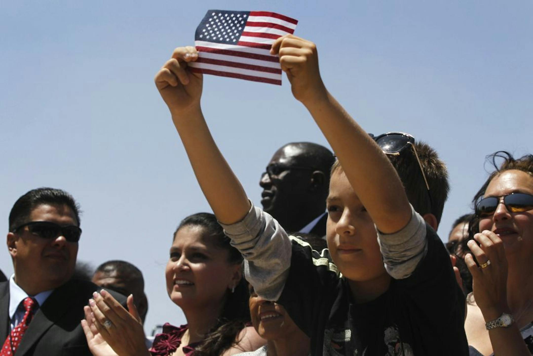 Audience members listen to President Barack Obama deliver his "Blueprint for Immigration Reform" at Chamizal National Memorial Park in El Paso, Texas in May 2011.
