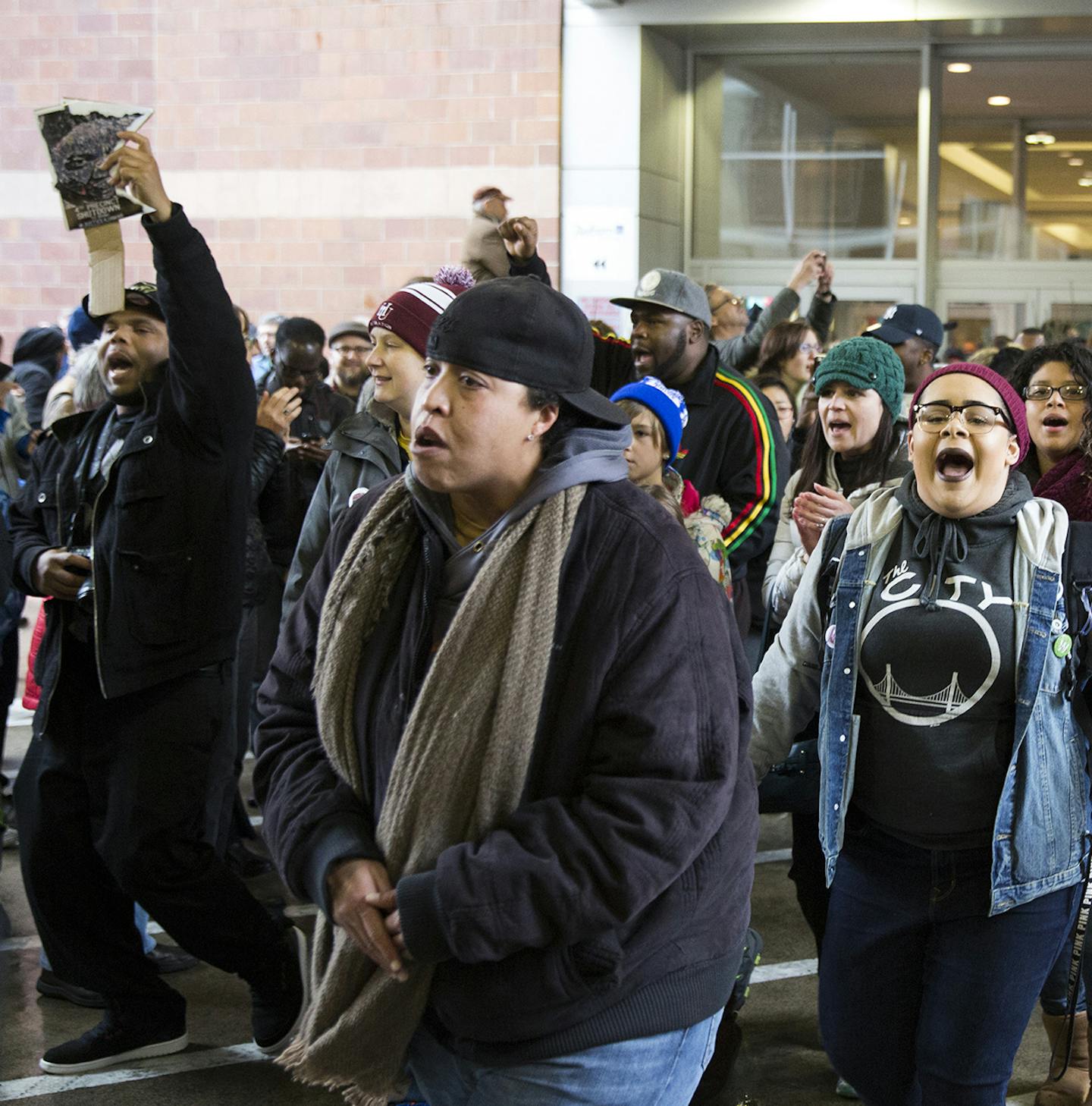 Black Lives Matter protesters cross the street to go down into the transit area after being pushed out of Mall of America by police in Bloomington on Wednesday, December 23, 2015. ] (Leila Navidi/Star Tribune) leila.navidi@startribune.com ORG XMIT: MIN1512231528301309