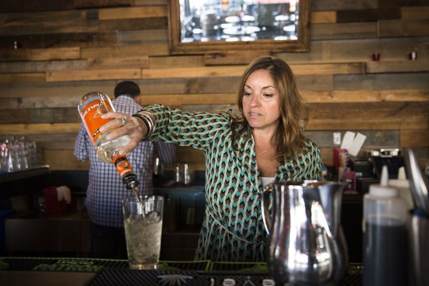 Owner Rebecca Illingworth makes a margarita behind the bar at Tinto Cocina + Cantina in Minneapolis on Tuesday, September 29, 2015. Some small businesses said the proposed Working Families Agenda provisions could cripple their businesses.