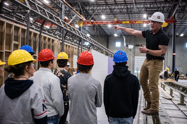 Shake Ekman gives a tour to students from St. Michael-Albertville High School on April 26, 2023. Shane Ekman has a job with AVA, a modular housing man