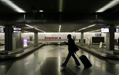 A lone traveler walks in the deserted baggage claim area for American Airlines, Thursday, April 10, 2008, at O'Hare International Airport in Chicago. Gerard Arpey, the chief executive officer of embattled American Airlines said Thursday, April 10, 2008, the cancellation of nearly 2,500 flights this week will cost the airline "in the tens of millions of dollars."