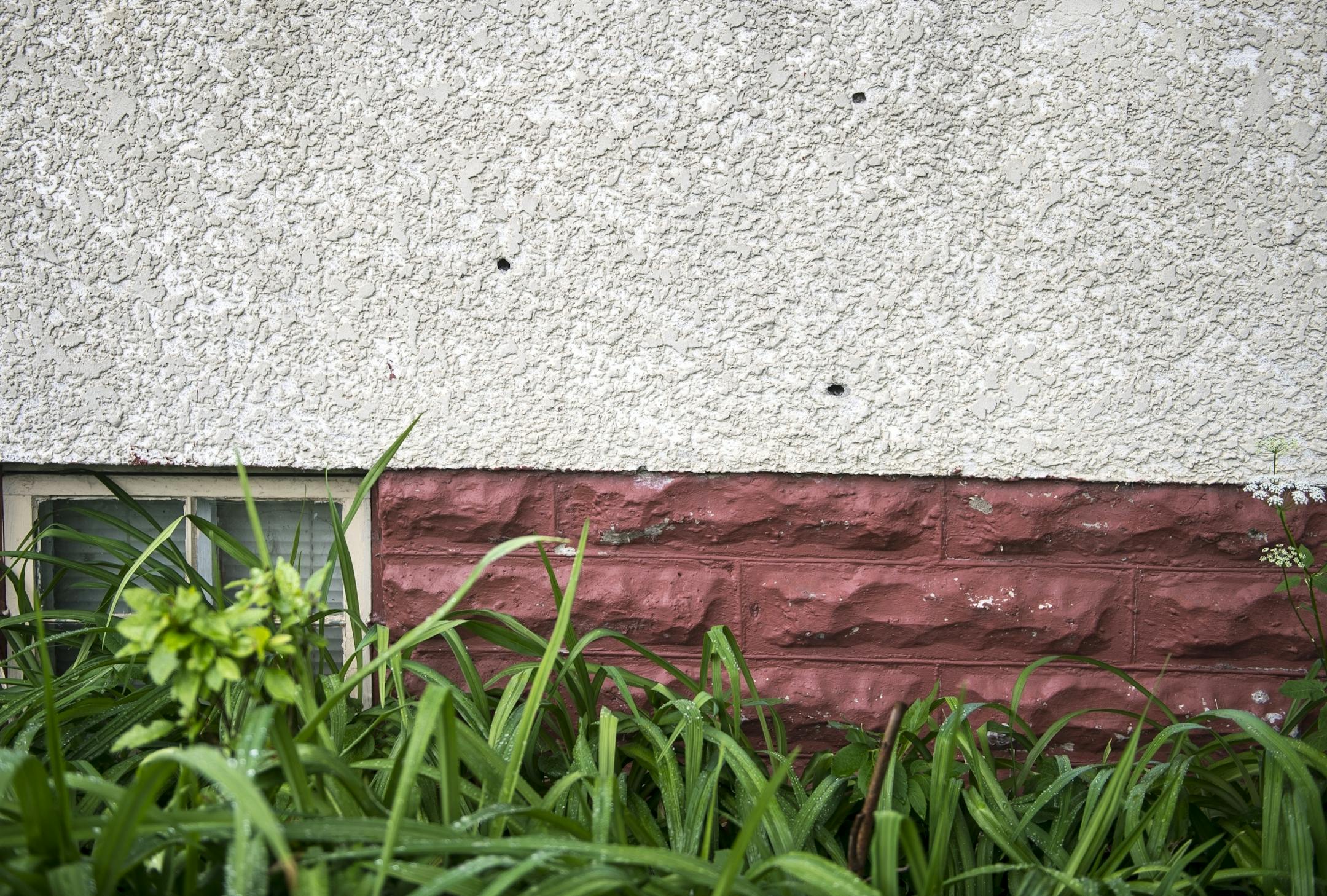 Bullet holes near the site of last night's fatal shooting.
