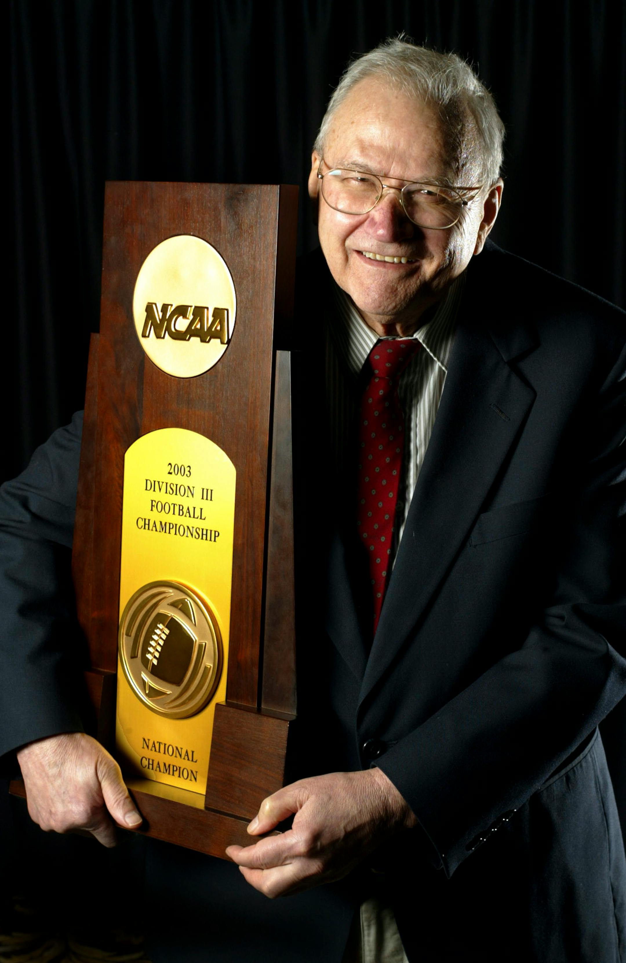 St. John's coach John Gagliardi held the 2003 Division III national championship trophy.