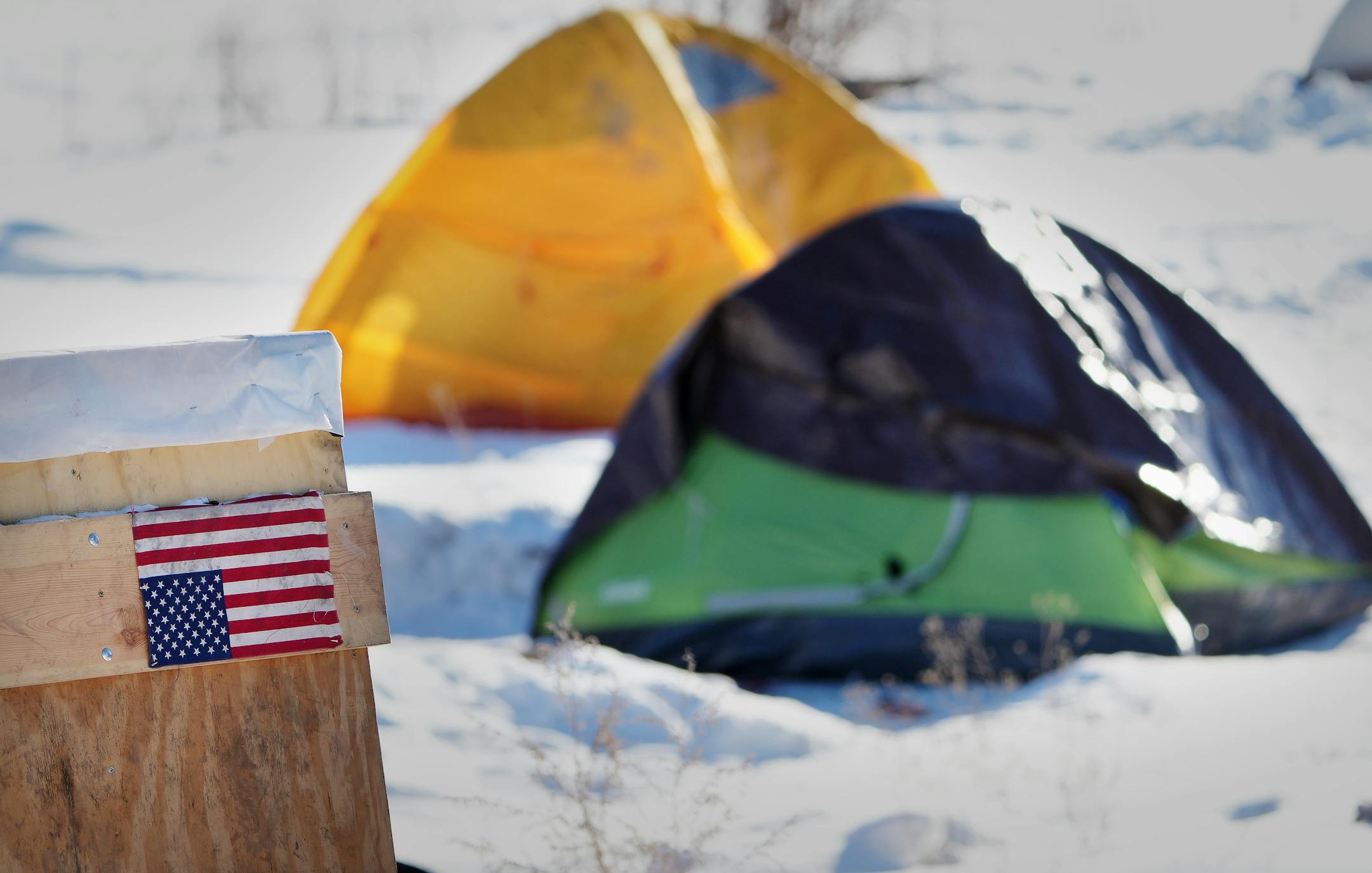 An American flag hangs upside down, seen as a symbol of a nation in distress, in a homeless encampment off of the 3000 block of Snelling Avenue, near Hiawatha Ave., during Hennepin County's "Point in Time," count of homeless people Thursday, Jan. 26, 2023 in Minneapolis.