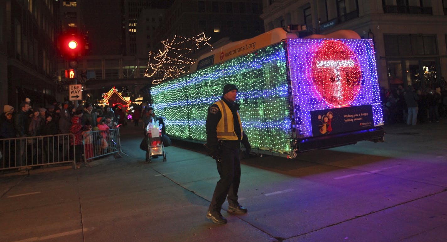 A police officer kept his eye and auto and human traffic as the Twinkle Bus made its way down the Nicollet Mall for the Target Holidazzle parade Friday, Nov. 23, 2012, in Minneapolis, MN.