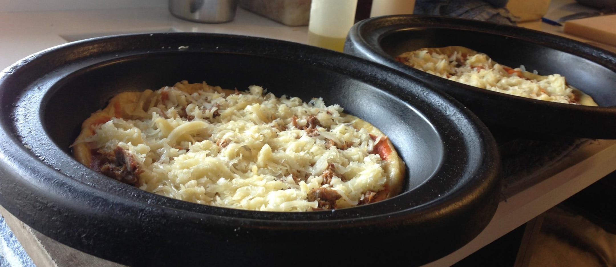 Pizzas wait for the oven at Pig Ate My Pizza
