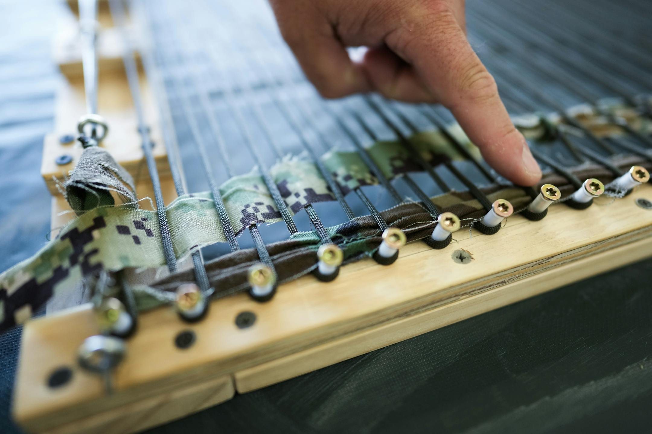 Army veteran and artist Jeffrey Stenbom demonstrated how he weaves American flags using old service member uniforms.