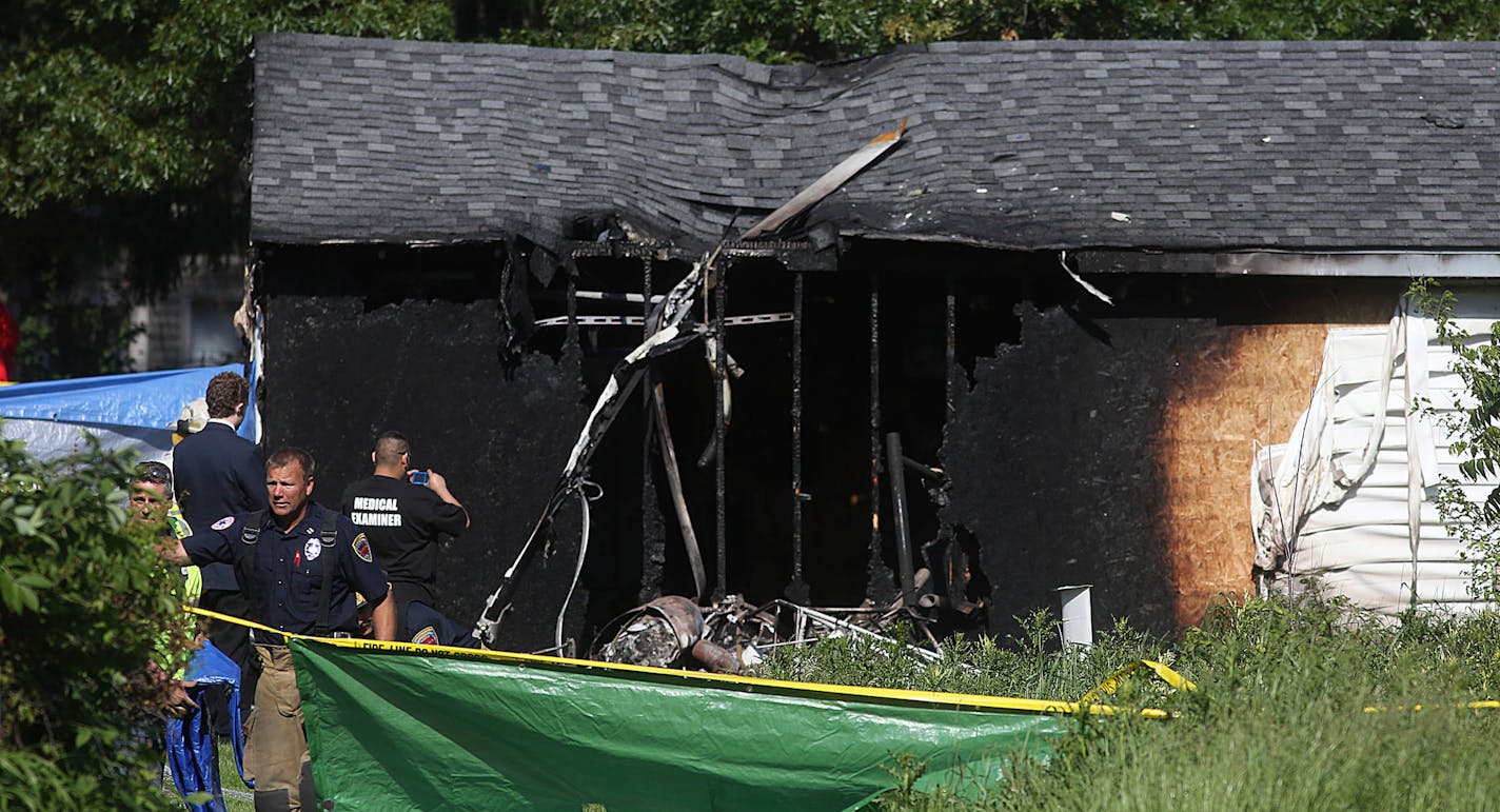 Emergency personnel and otherswere at the scene where a helicopter crashed into a garage in a Maplewood neighborhood Wednesday morning.