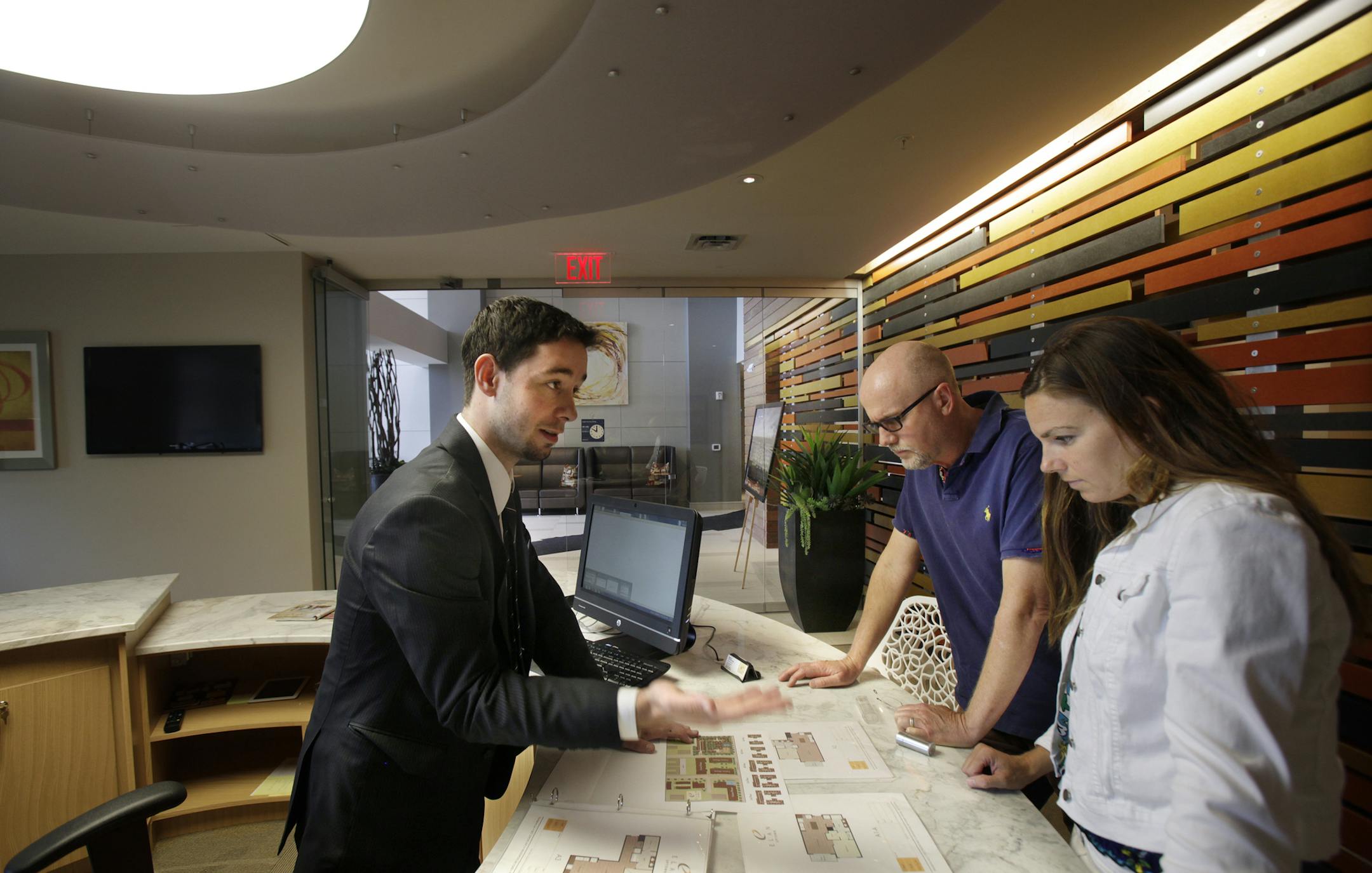 Jimmy Hill of Elan (left) shows Blake Rice and Anne Kidder of Minnetrista, MN floor plans of the units available at 2837 Dupont Avenue South in Minneapolis, MN on August 13, 2013. ] JOELKOYAMA‚Ä¢joel koyama@startribune