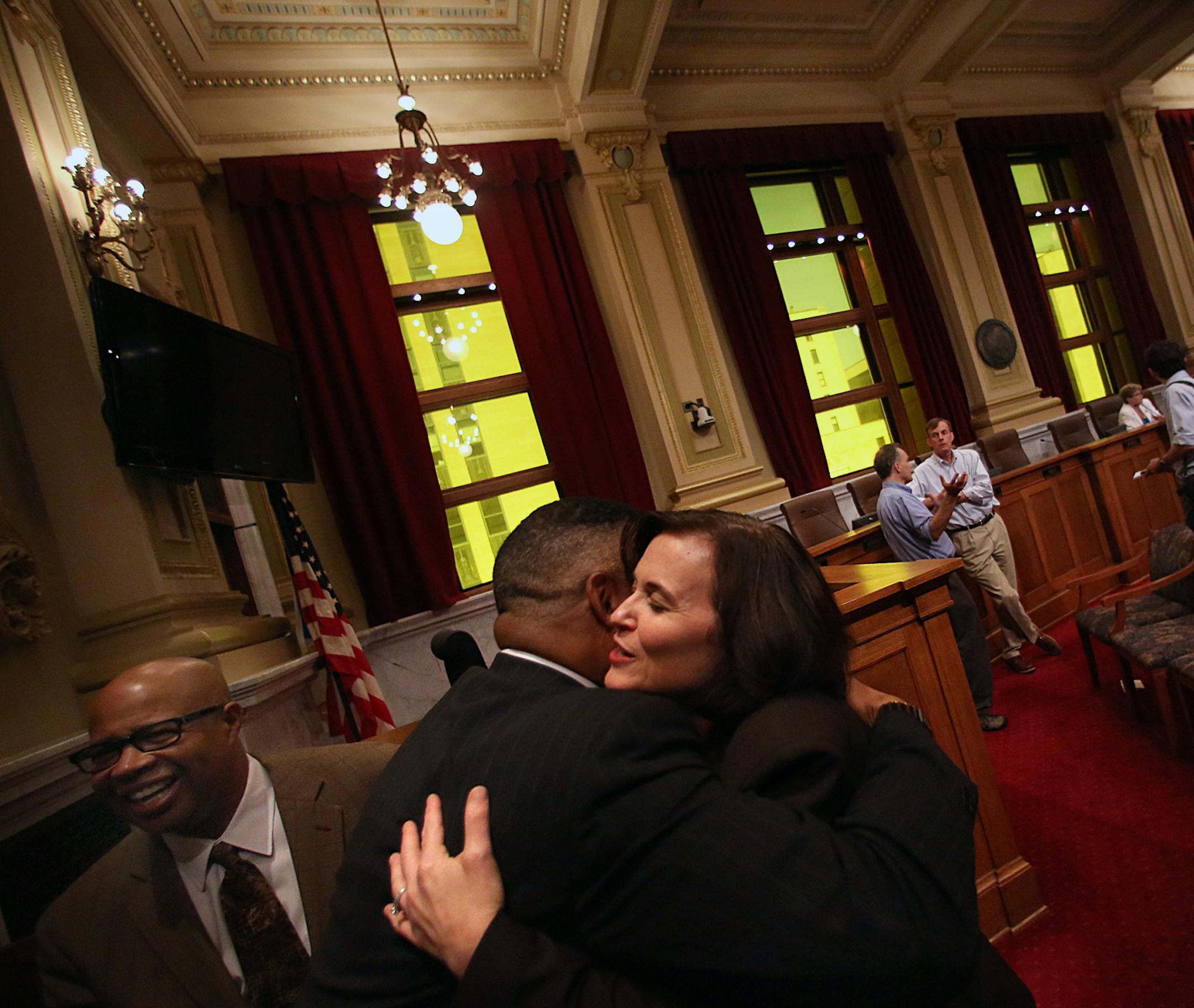 Minneapolis Mayor Betsy Hodges embraced a well-wisher following the address. Gary Cunningham, Hodge‚Äôs spouse, is at left. ] JIM GEHRZ ‚Ä¢ jgehrz@startribune.com / Minneapolis, MN / August 14, 2014 / 11:00 AM / BACKGROUND INFORMATION: Minneapolis Mayor Betsy Hodges delivered her first budget address before the City Council in the Minneapolis City Hall City Council Chambers.