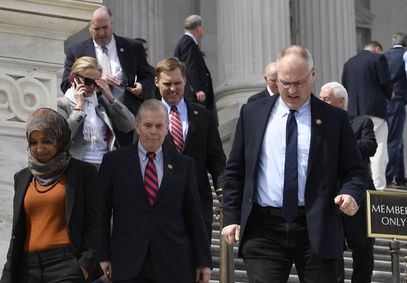 Members of the House of Representatives walk down the steps of Capitol Hill in Washington, Friday, March 27, 2020, after passing a coronavirus rescue package. Acting with exceptional resolve in an extraordinary time, the House rushed President Donald Trump a $2.2 trillion rescue package, tossing a life preserver to a U.S. economy and health care system left flailing by the coronavirus pandemic. (AP Photo/Susan Walsh)