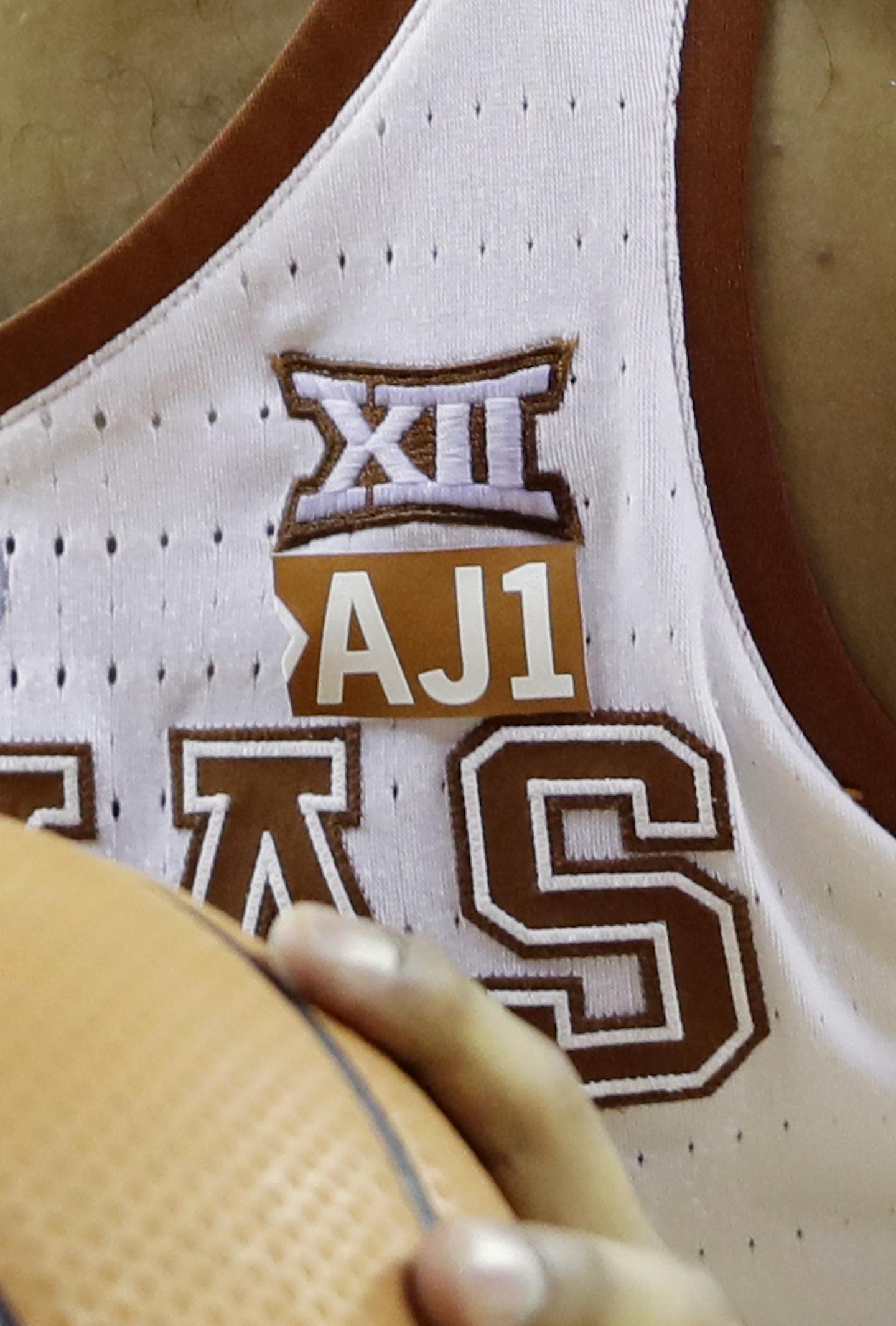 Texas forward Jericho Sims (20) shoots a free throw against TCU during the second half of an NCAA college basketball game, Wednesday, Jan. 10, 2018, in Austin, Texas. Texas won in double overtime 99-98. Sims and teammates are wearing an "AJ1" logo to honor teammate Andrew Jones, who has been diagnosed with leukemia. (AP Photo/Eric Gay) ORG XMIT: OTK