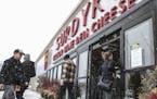 People enter The Surdyk's liquor store in the snow in Minneapolis on Sunday, March 12, 2017. The liquor store has gotten a head start on opening for b