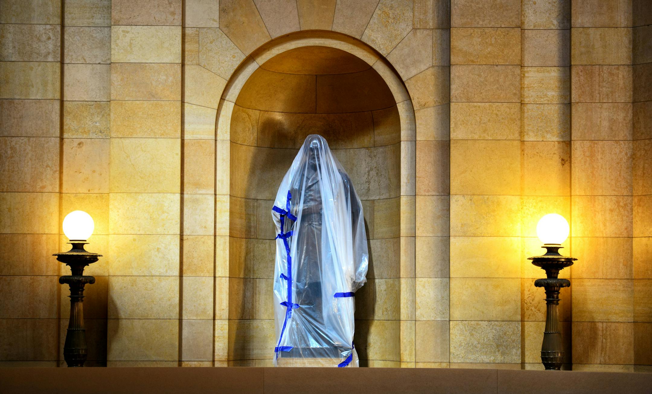 Statues of Civil War soldiers that ring the State Capitol rotunda’s second-floor overlook were covered by workers for protection from the ongoing renovations.