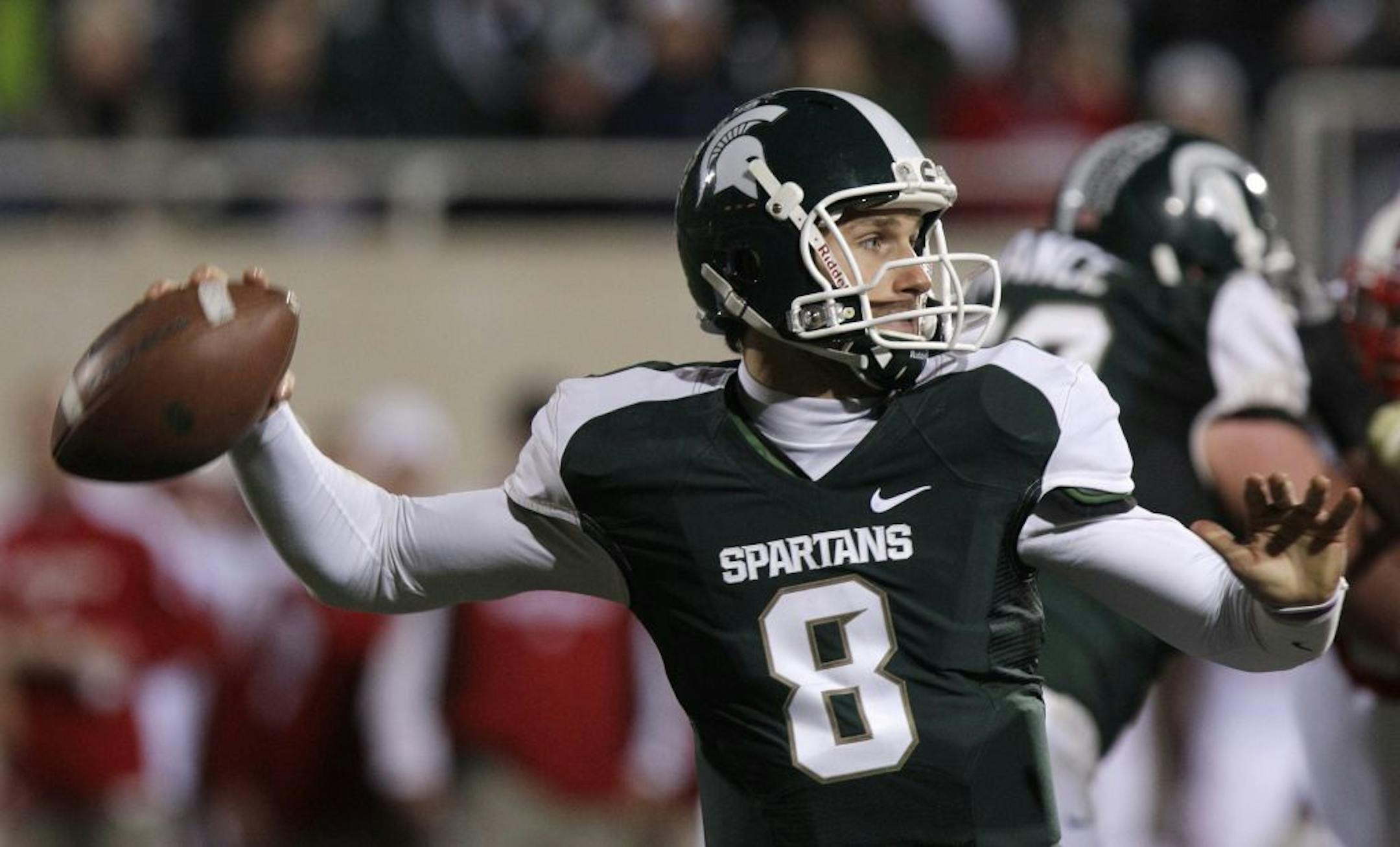 Michigan State quarterback Kirk Cousins throws during the fourth quarter of an NCAA college football game against Wisconsin in East Lansing, Mich., Saturday, Oct. 22, 2011. With the game tied with 4 seconds left, Cousins threw a 44-yard Hail Mary to win the game.