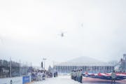 Military helicopters fly over the rink at the start of Hockey Day in Minnesota in White Bear Township, Minn., on Saturday, Jan. 28, 2023. Hockey Day M