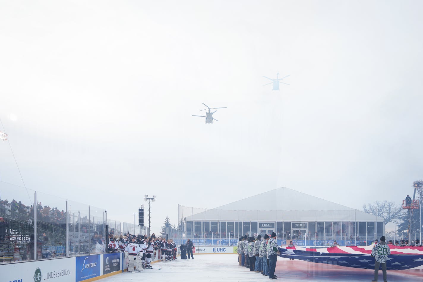 Military helicopters fly over the rink at the start of Hockey Day in Minnesota in White Bear Township, Minn., on Saturday, Jan. 28, 2023. Hockey Day Minnesota 2023 in White Bear Township. ] SHARI L. GROSS • shari.gross@startribune.com