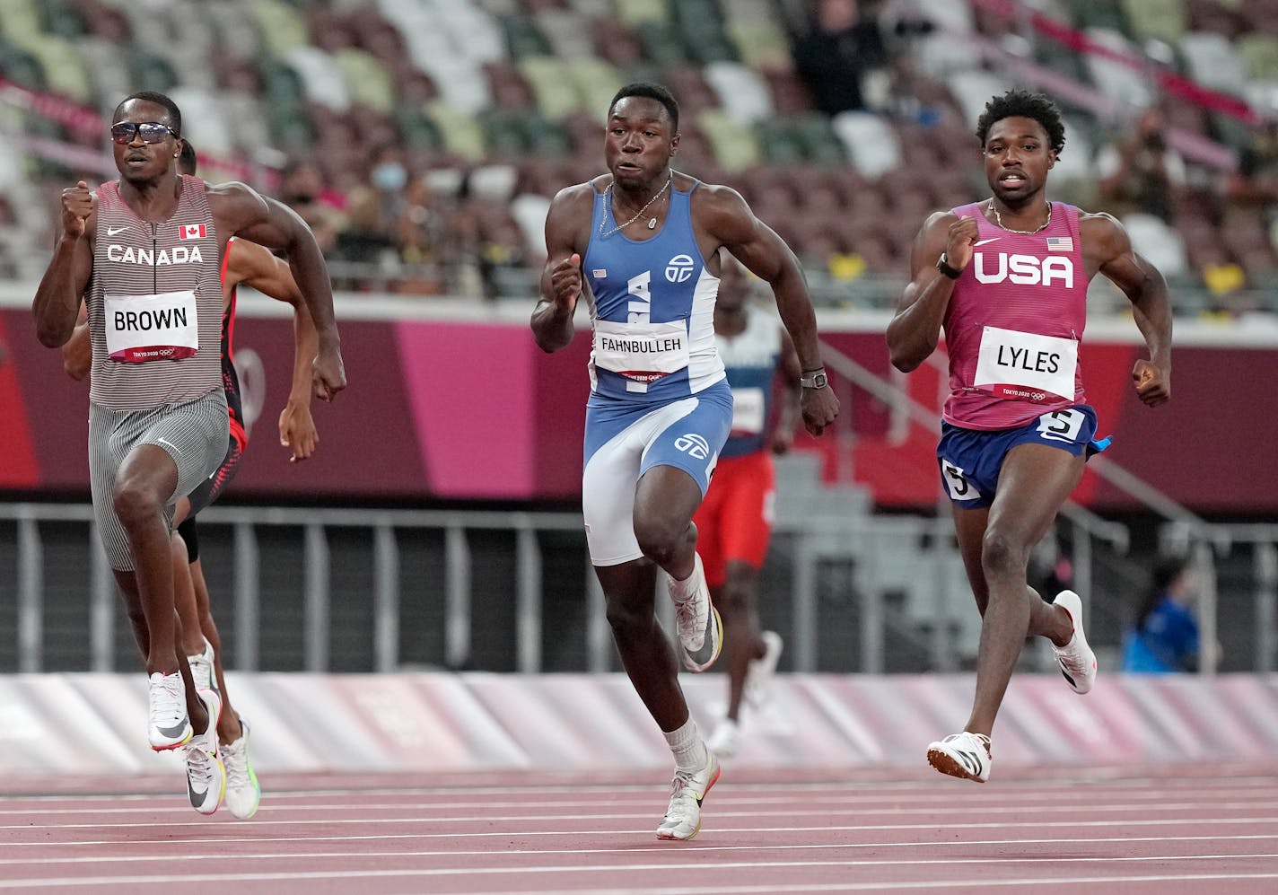 Aaron Brown, of Canada, Joseph Fahnbulleh, of Liberia and Noah Lyles, of United States race in a men's 200-meter semifinal at the 2020 Summer Olympics, Tuesday, Aug. 3, 2021, in Tokyo, Japan. (AP Photo/Martin Meissner)