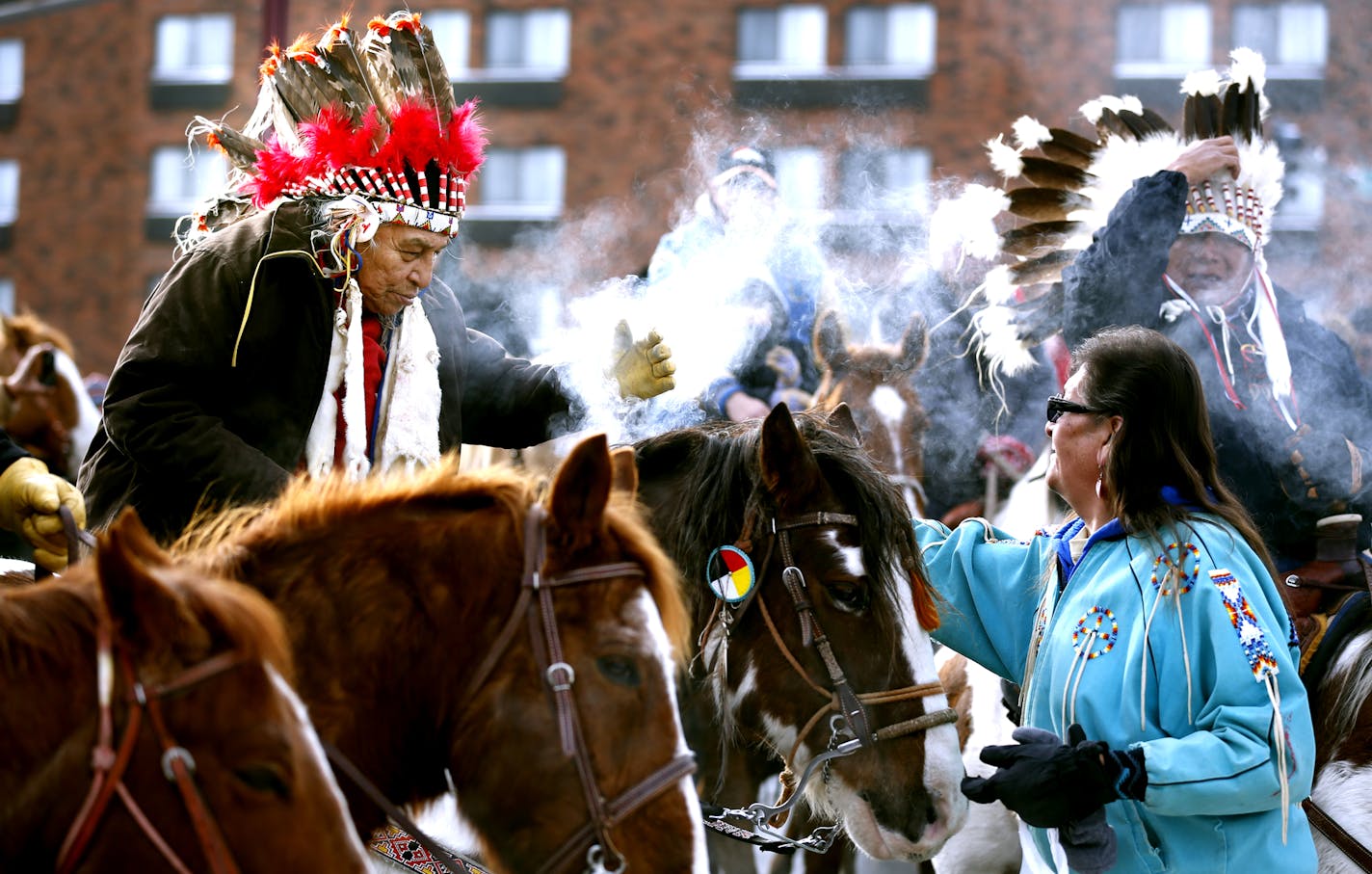 A rider received sage smoke from Corbie of Crow Creek, South Dakota, after arriving at Reconciliation Park for the Dakota Wokiksuye Memorial Ride Thursday in Mankato.